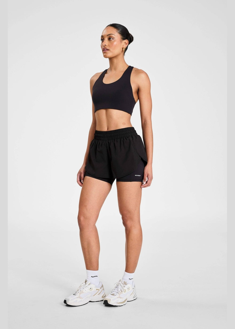 ALLFENIX EcoSculpt Running Short in Black, three-quarter view